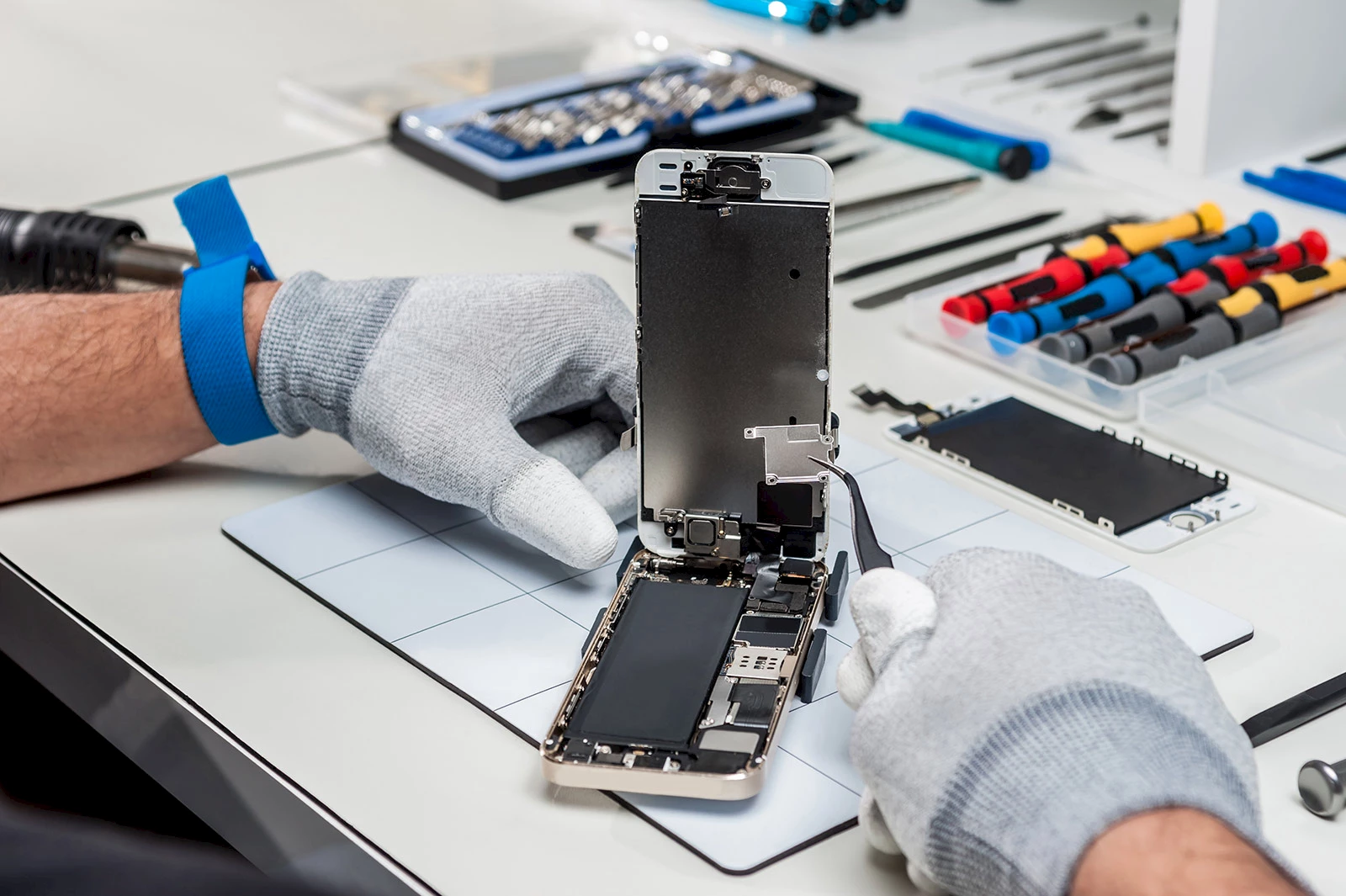 Technician repairing a smartphone.